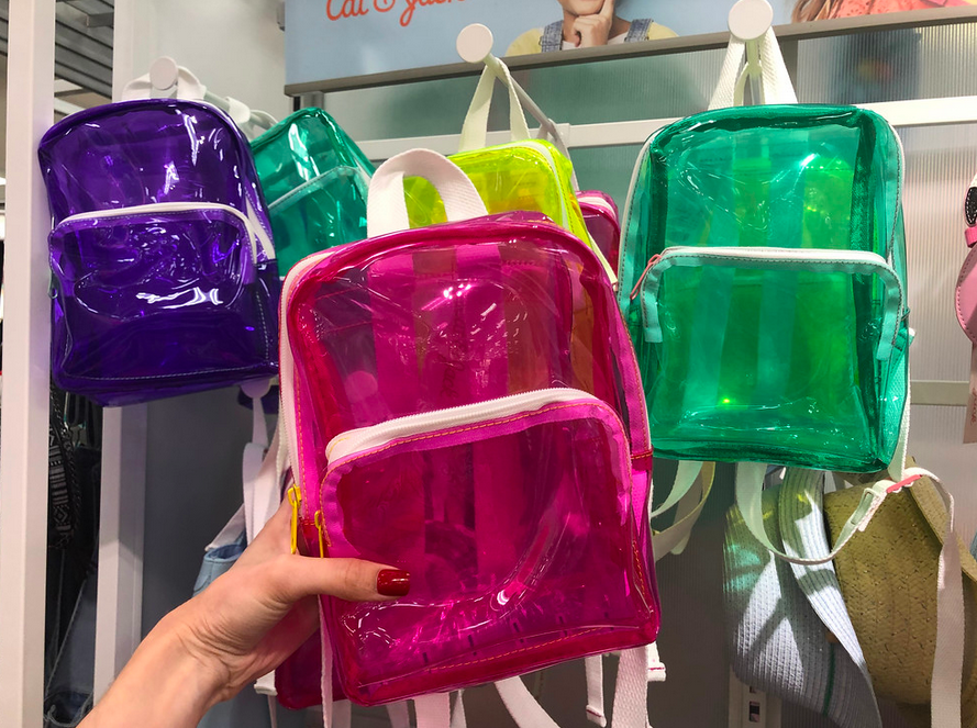 Woman holding pink Cat & Jack Kids clear Backpack in Target
