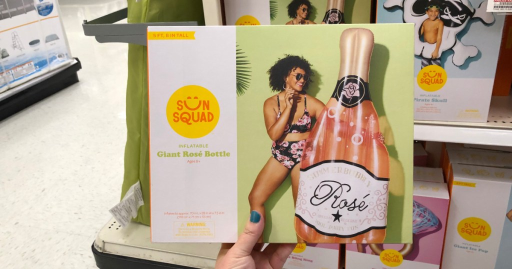 woman holding champagne pool float at target