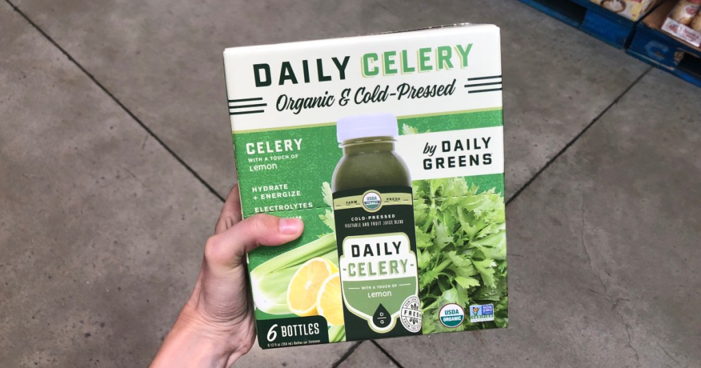 woman holding box of celery juice at costco