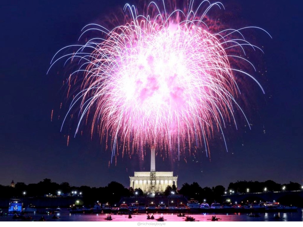 large pink purple firework exploding in sky