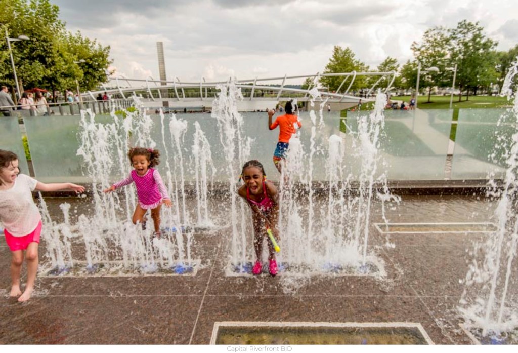 kids playing on splash pad park with water