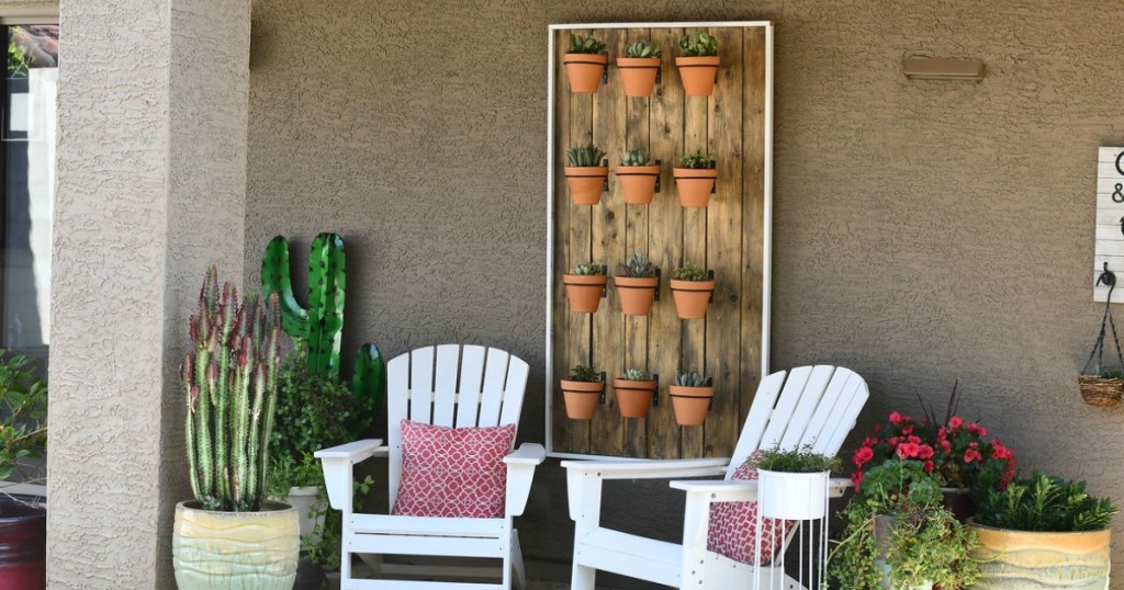 hanging succulent wall on patio with chairs 