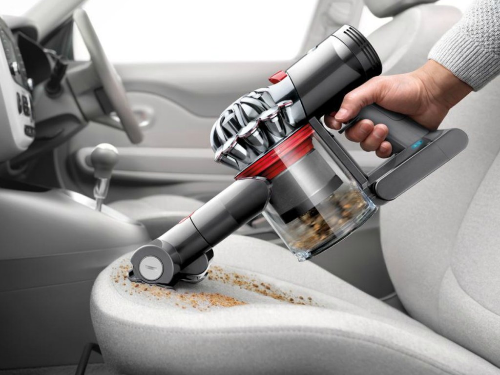Dyson V7 Motorhead Extra Cordless Stick Vacuum Cleaner cleaing crumbs from seat in car