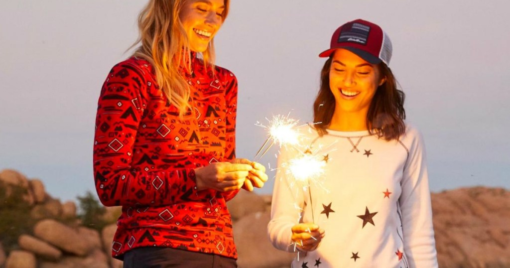 Women standing in Eddie Bauer Clothes with sparklers