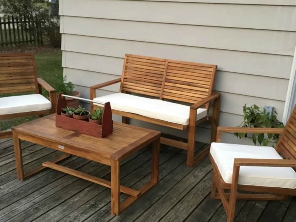 porch with table and chairs with cushions on it