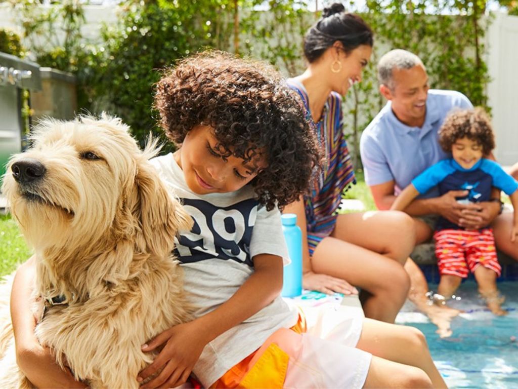 Family in pool with dog