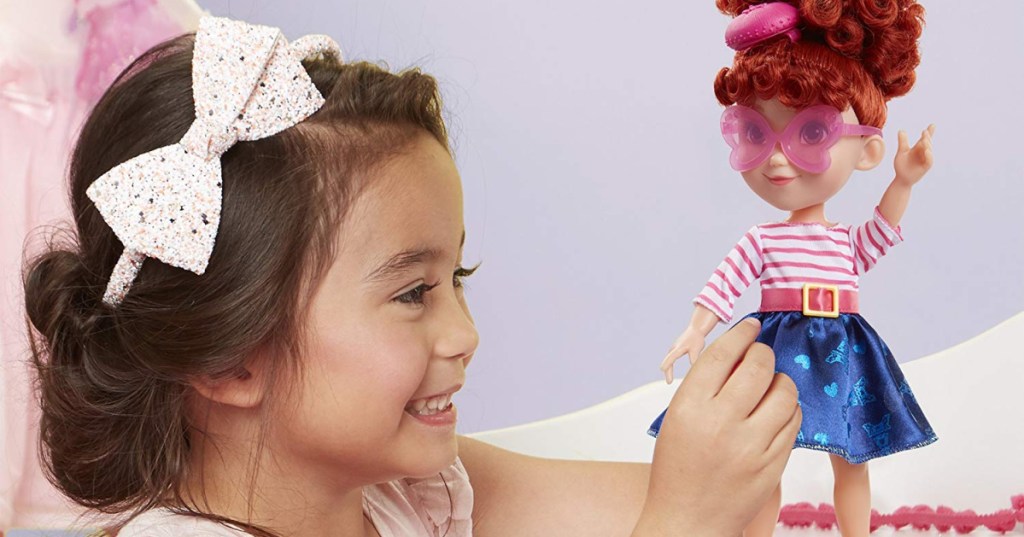 girl playing with fancy nancy doll