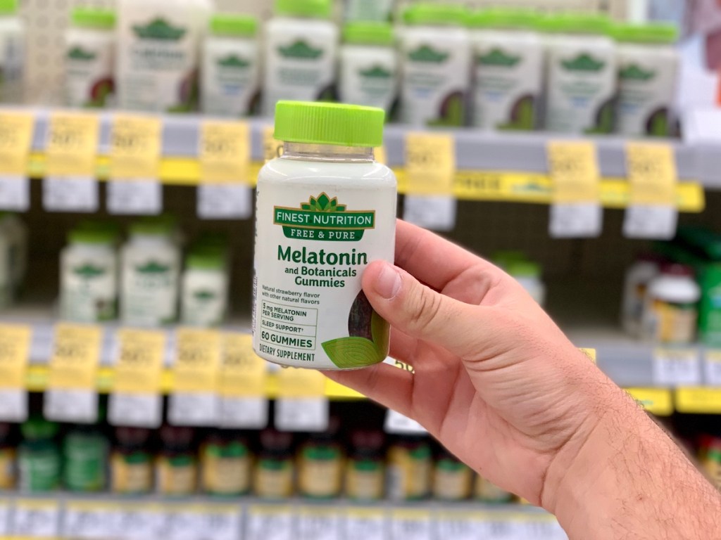 hand holding Finest Nutrition Free & Pure Melatonin Gummies