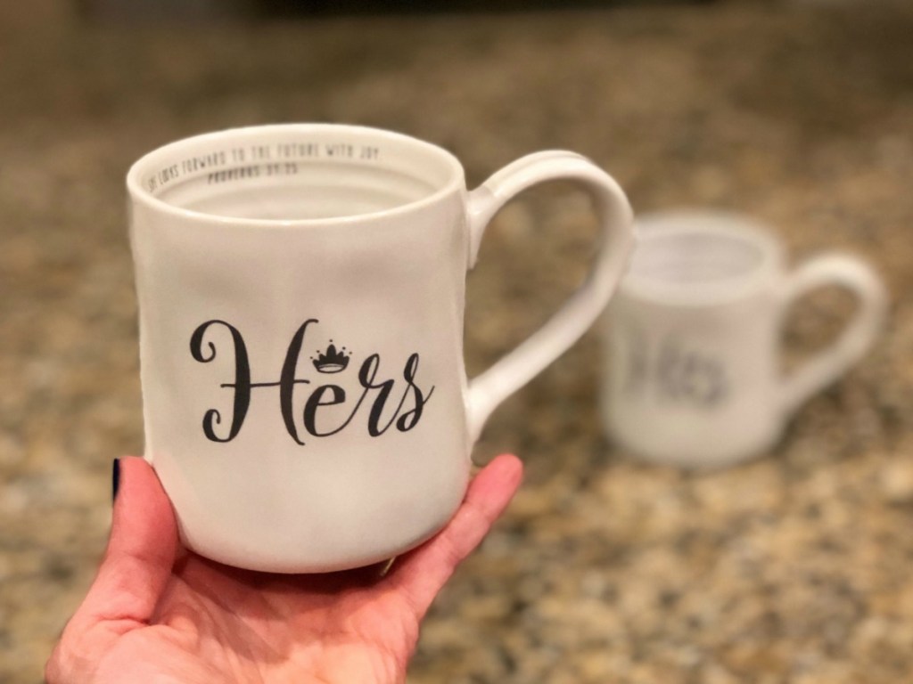 Hers hand-thrown Coffee Mug held up above countertop