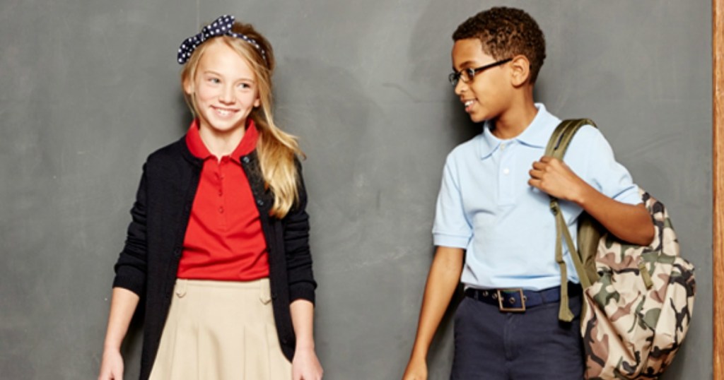 Kids in school uniforms in front of a chalk board