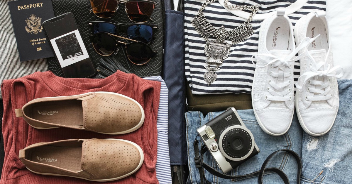suitcase packed with apparel, accessories and shoes
