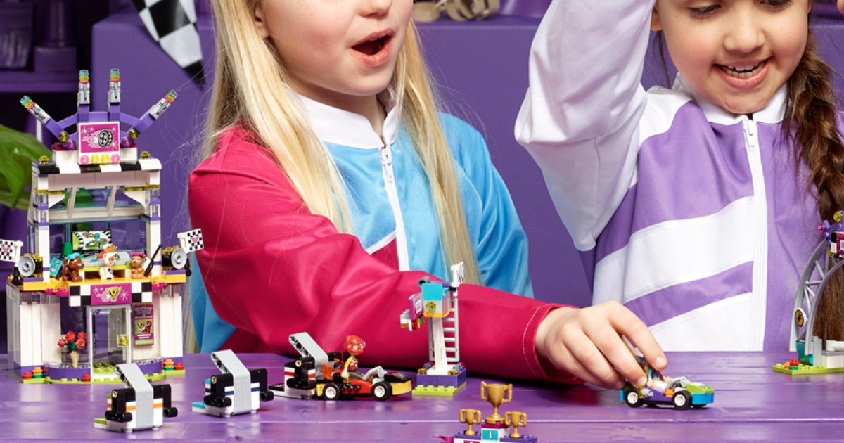 two girls playing with the Lego friends, big race day set