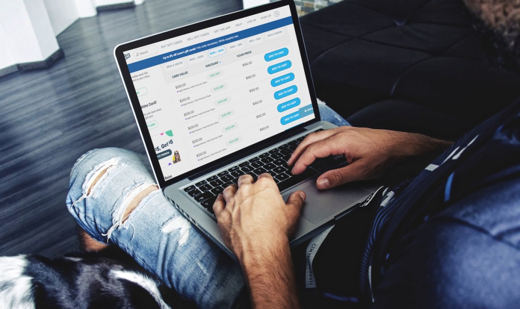 man using macbook with adidas deals on screen