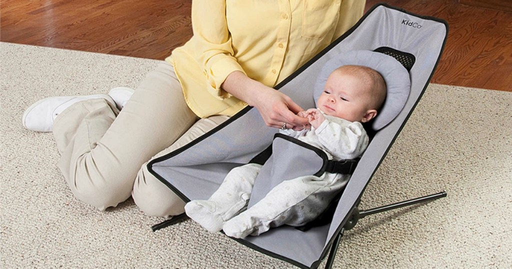 baby resting in midnight travel bouncer