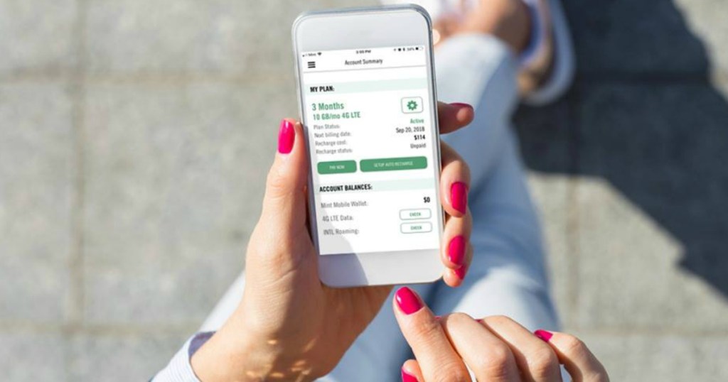 lady holding a phone and looking at her mint mobile plan