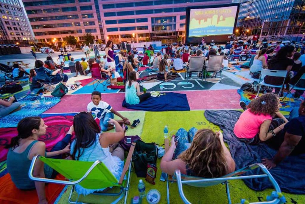 colorful outdoor space with people and outdoor movie