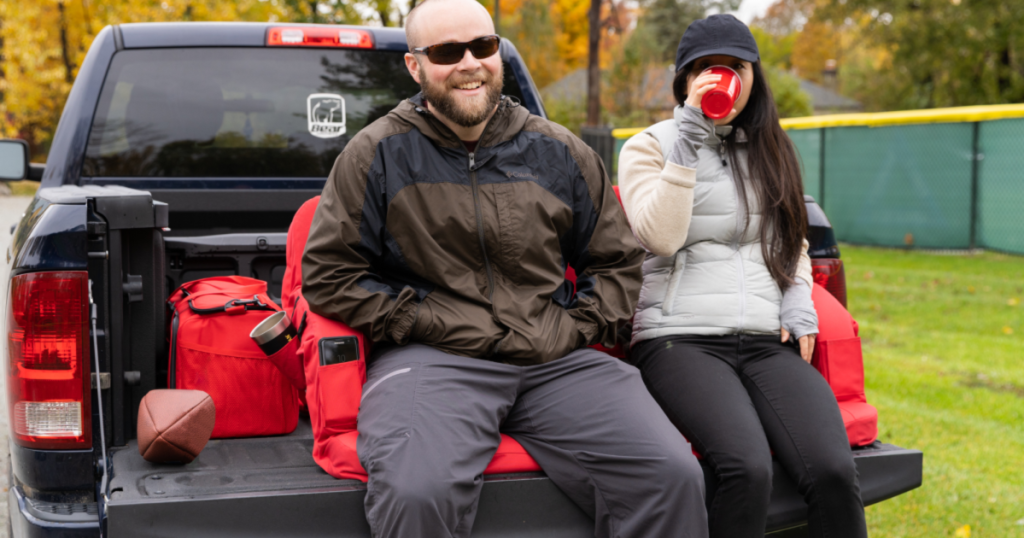 Ozark Trail Adjustable Tailgate Padded Couch on truck with man and woman sitting on it