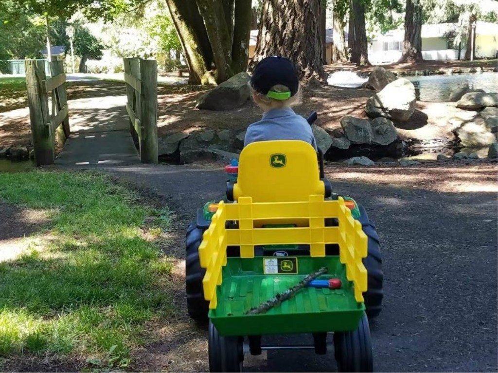 boy driving away on Peg Perego John Deere Tractor Ride-on