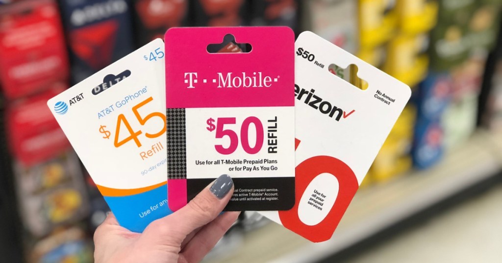 woman holding 3 prepaid phone cards at store