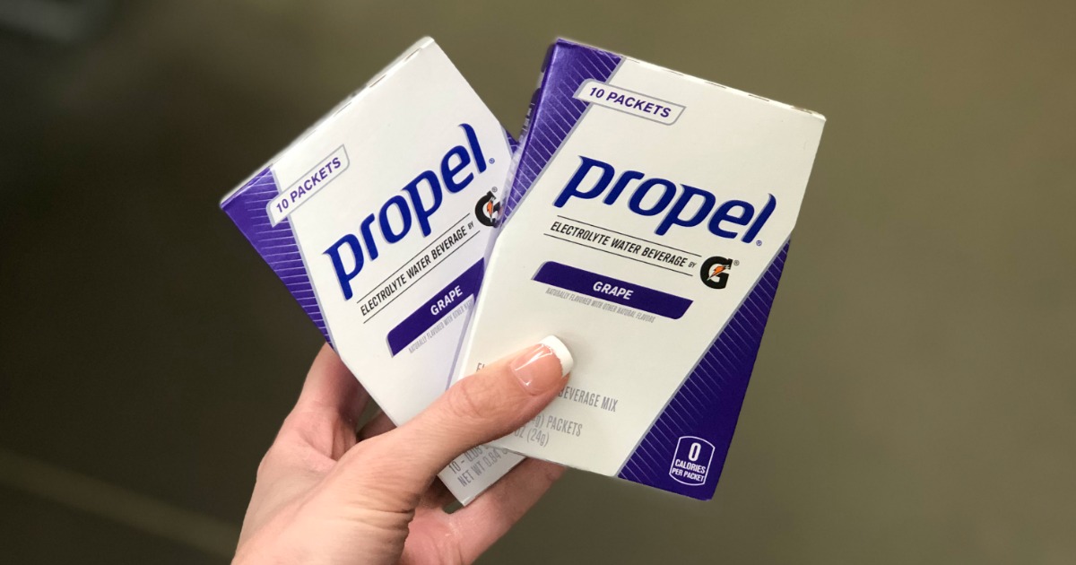 Woman holding Propel packets in grape flavor