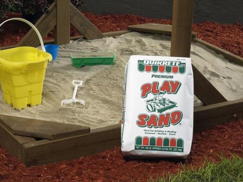 Quikrete Play Sand sitting next to a sandbox