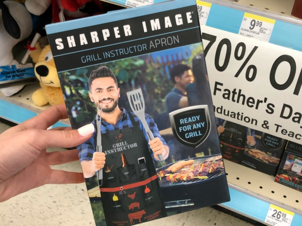 hand holding box with picture of man in apron