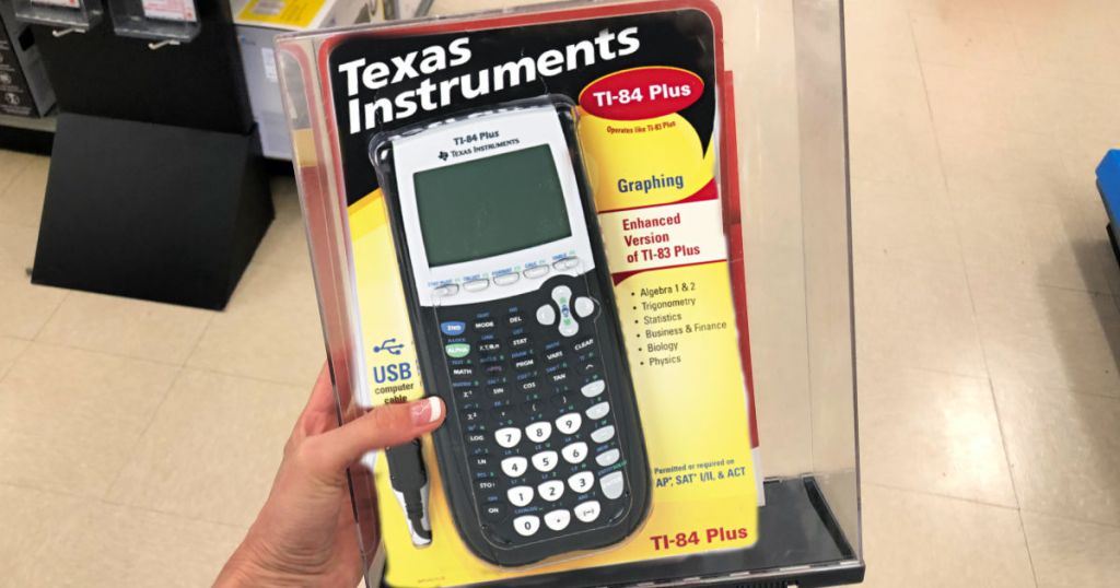 Hand holding Texas Instruments TI-84 Plus Graphing Calculator