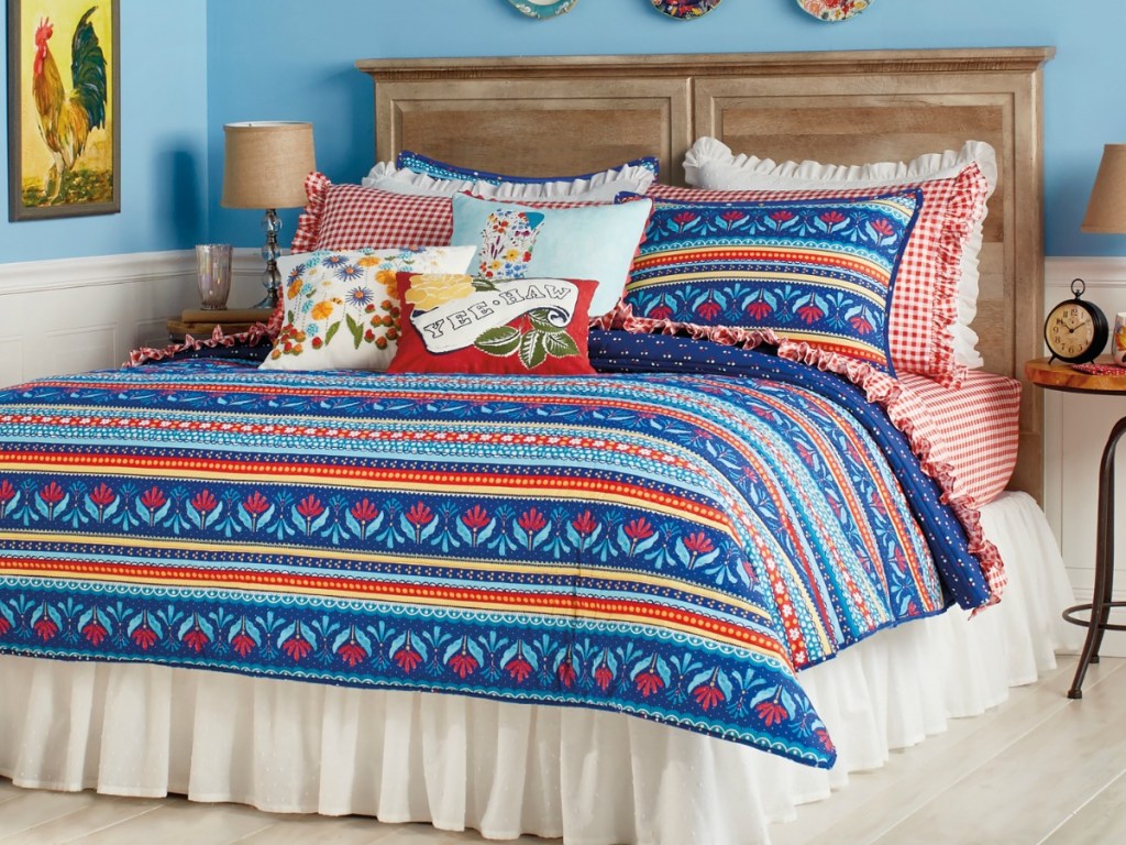 striped quilt on bed with throw pillows