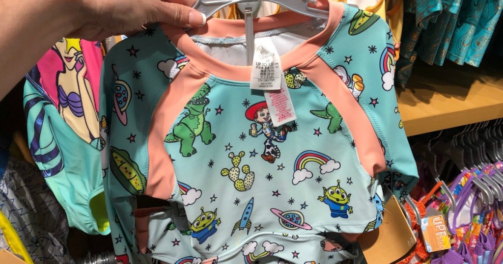 woman holding Toy Story 2-piece swimsuit