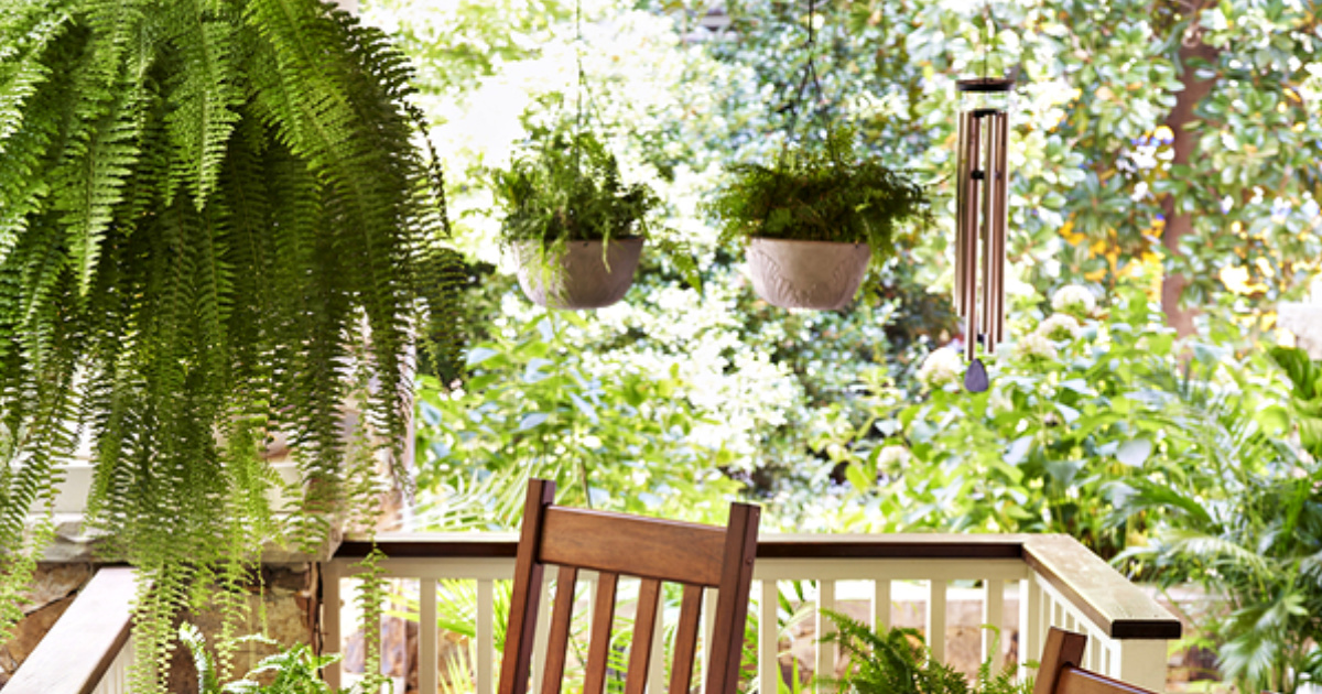 wind chimes and hanging potted plants on porch