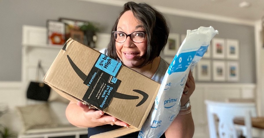 woman holding up two amazon packages