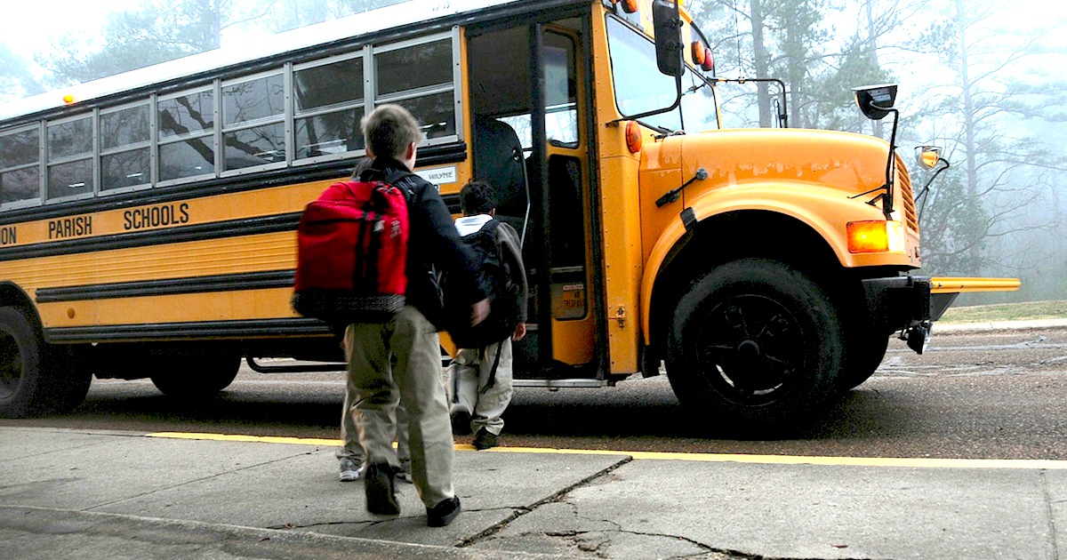 kids walking onto yellow school bus