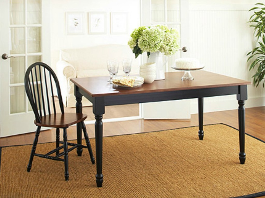 brown table with chair and flowers on top
