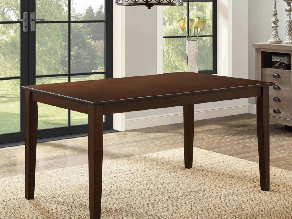 brown table near window on carpet