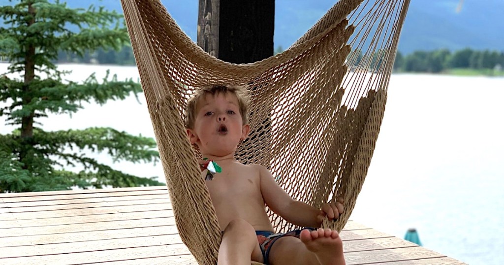 little boy sitting in hammock swing