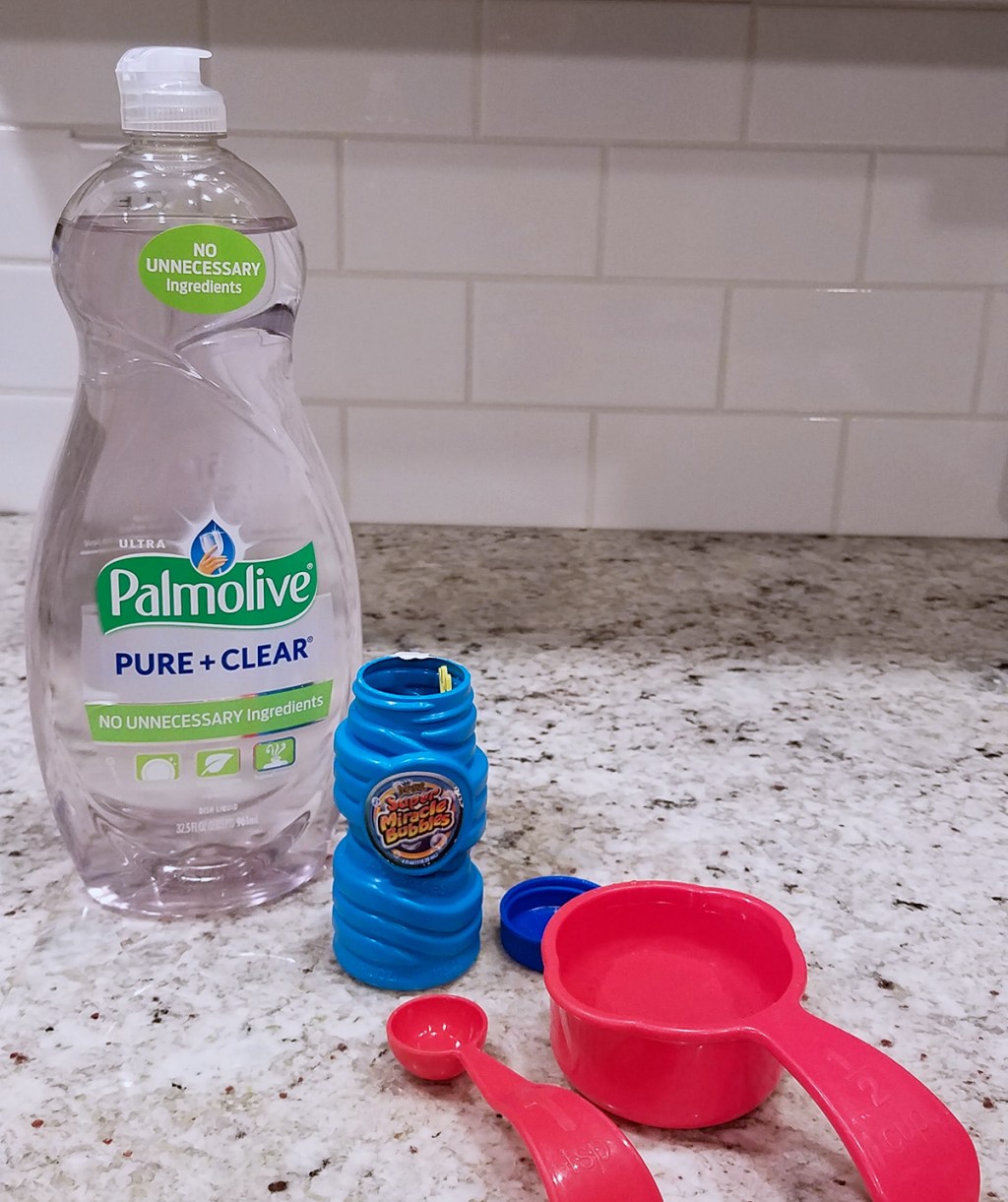 dish soap, water, measuring cups on counter