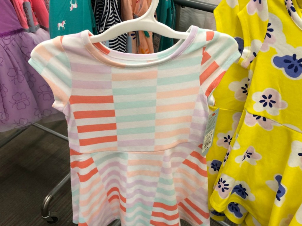 dress with multi-colored stripes on hanger in store