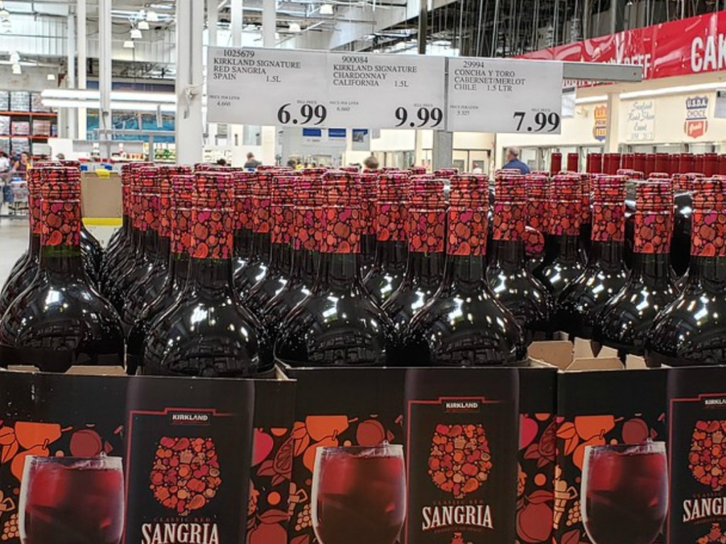 bottles of red wine near price tags in store