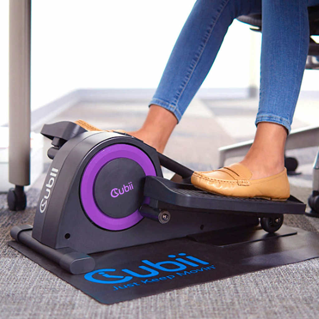 woman with flats on using cubii under desk elliptical