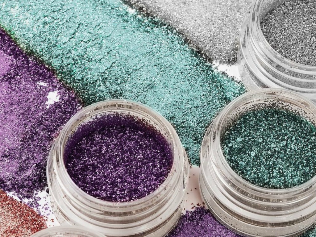 open containers of glitter make up spread on counter