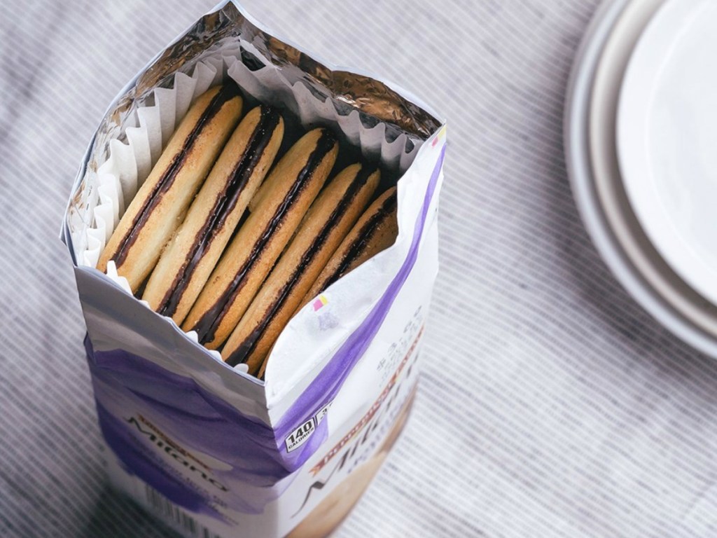 box of cookies open on table by plate