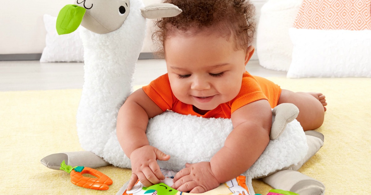 baby on carpet playing with toys