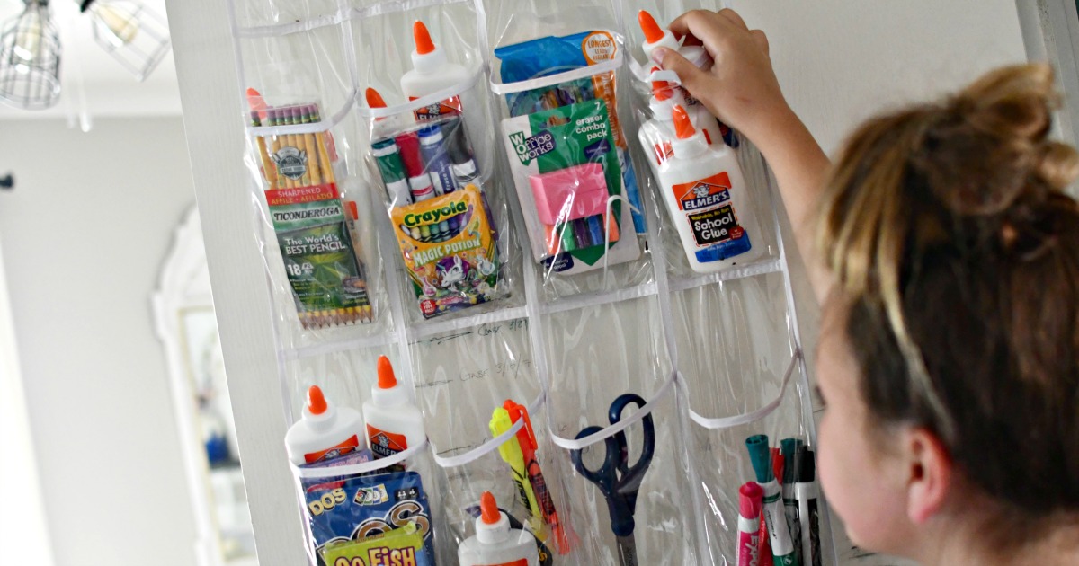 grabbing school supplies from shoe organizer