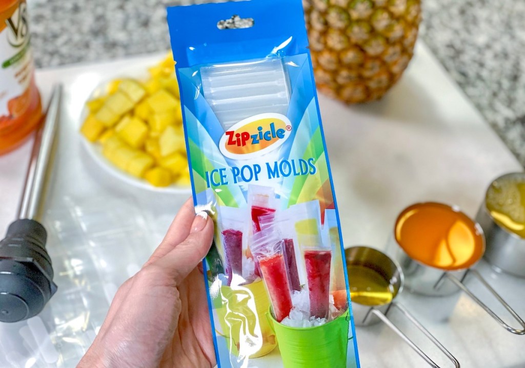 hand holding a pack of ice pop molds