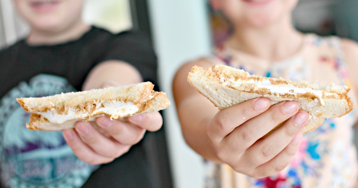kids holding nutterbutter sandwiches