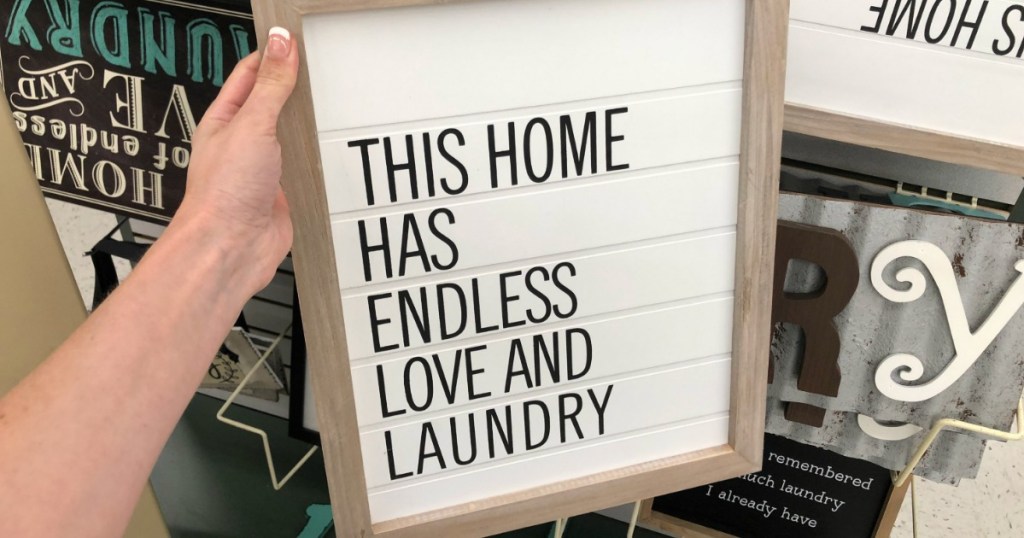 hand holding a white laundry sign in store