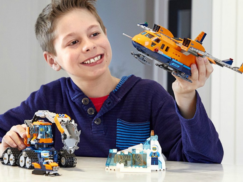 boy playing with legos at table