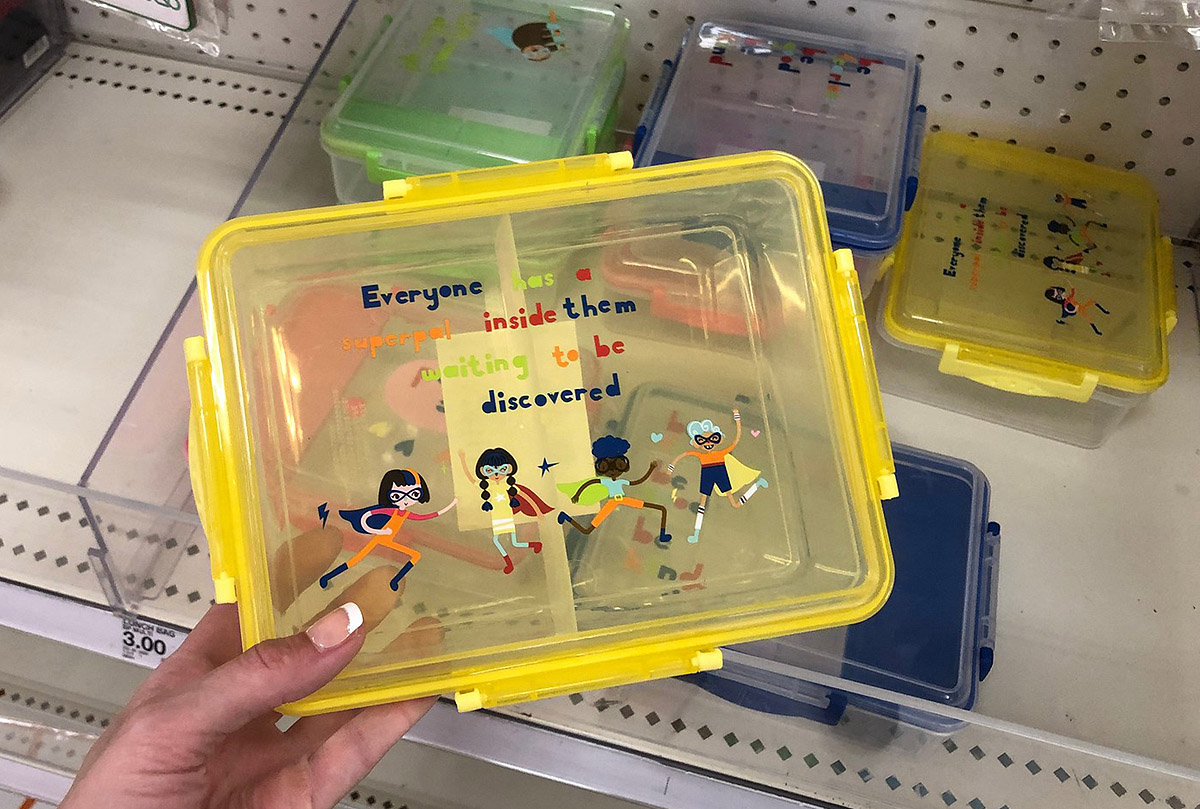 clear lunch boxes in yellow, blue, and green in store