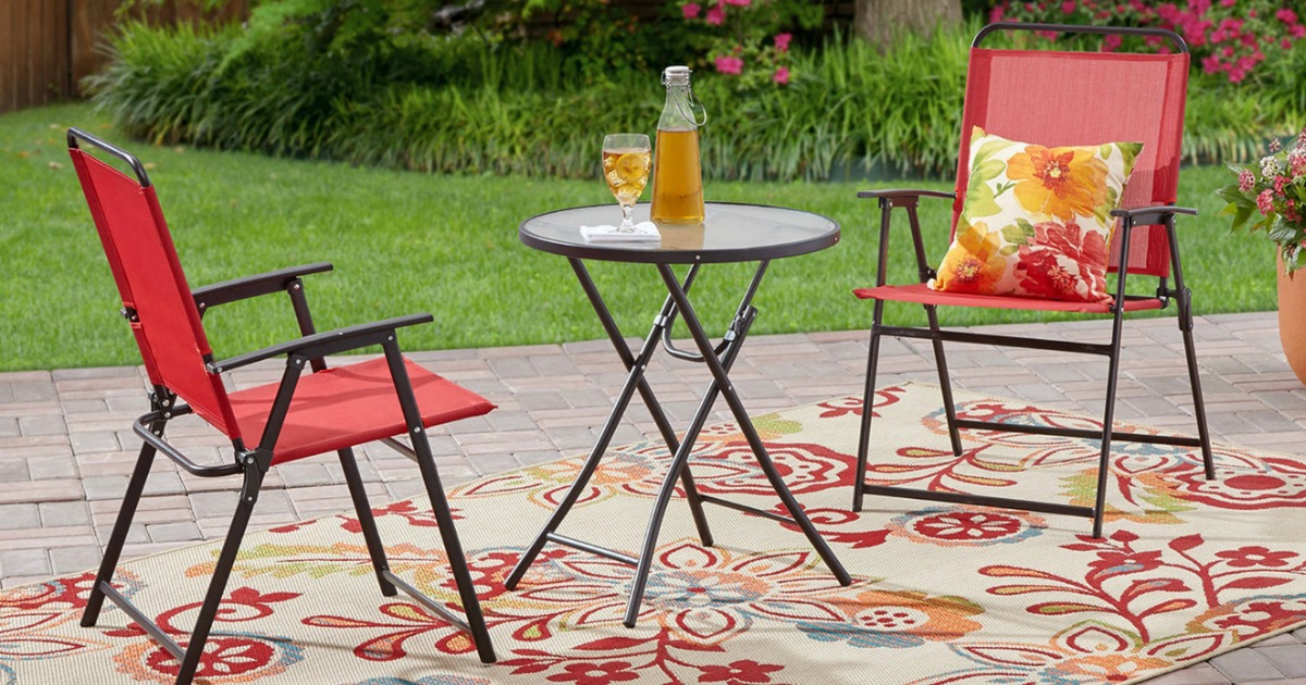 chairs and small table outside by grass