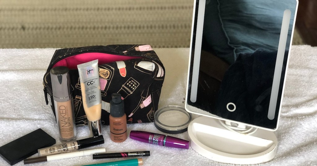 make up bag with various products and mirror
